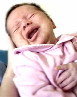 In some cases, babies who will later be diagnosed with Autism display hyersensitivity, and stiffen when hugged or cuddled. This contact is unpleasant due to sensory overload.